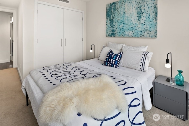 bedroom with a closet and light colored carpet