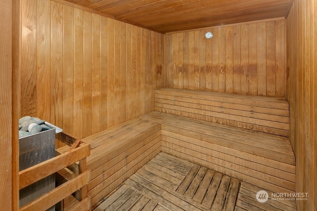 view of sauna featuring wood walls and wooden ceiling