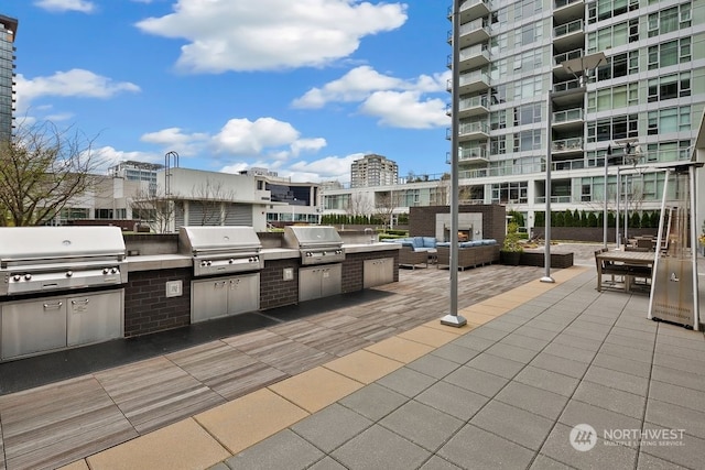 view of terrace featuring a balcony and area for grilling