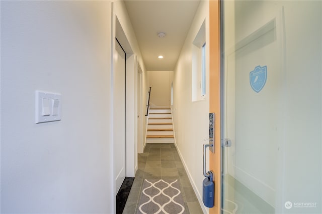 corridor with dark tile flooring