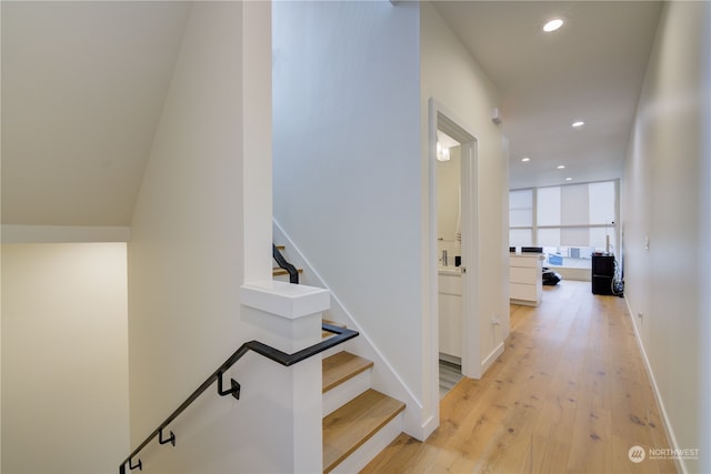 hallway with light hardwood / wood-style flooring