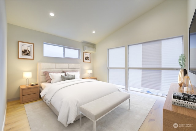 bedroom featuring lofted ceiling, access to outside, an AC wall unit, and light hardwood / wood-style floors