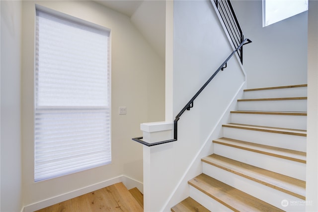 staircase with light wood-type flooring