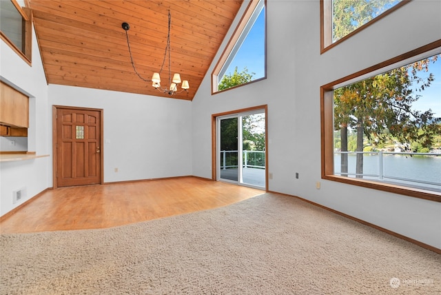 interior space with high vaulted ceiling, an inviting chandelier, light hardwood / wood-style floors, and wooden ceiling