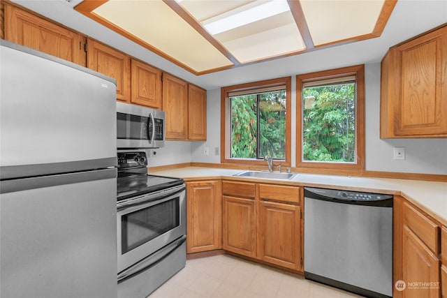 kitchen featuring light tile flooring, sink, and stainless steel appliances