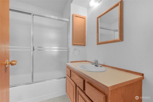 bathroom featuring vanity, combined bath / shower with glass door, and tile flooring