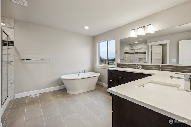 bathroom with backsplash, tile patterned floors, vanity, and independent shower and bath