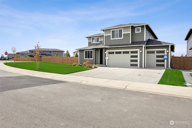 view of front of home with a garage and a front yard