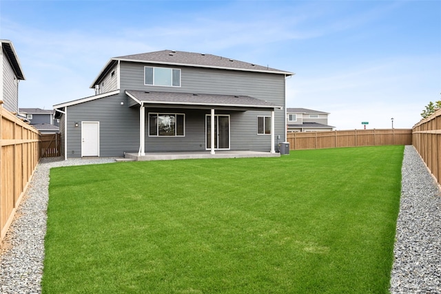 back of house featuring a lawn, a patio, and central air condition unit