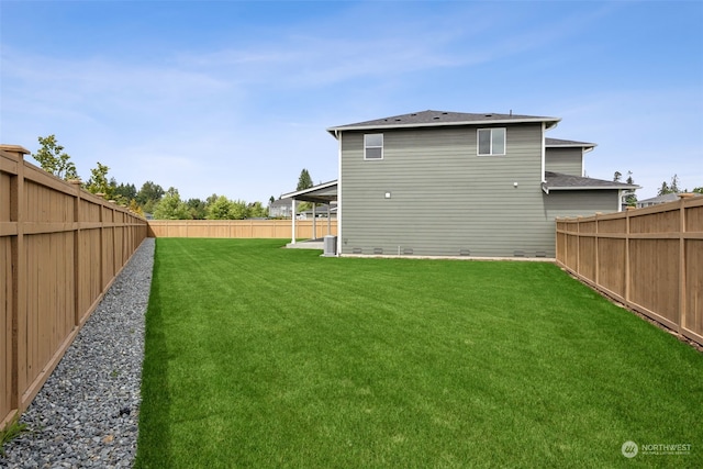 back of house featuring a lawn and a patio