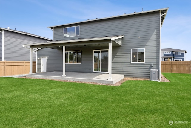 rear view of house with a lawn, a patio, and cooling unit