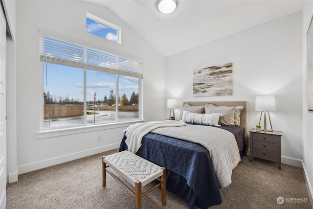 carpeted bedroom featuring lofted ceiling