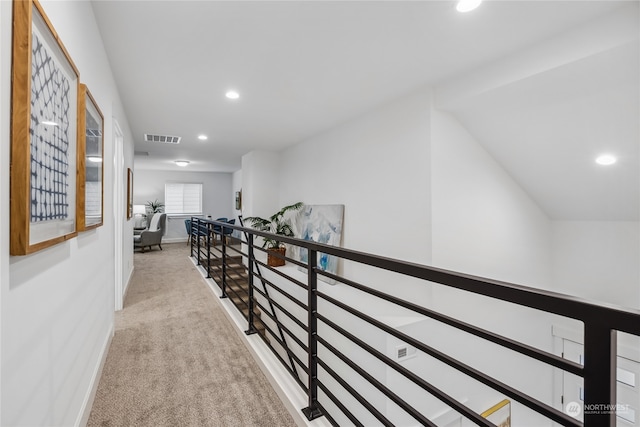 hallway featuring light colored carpet