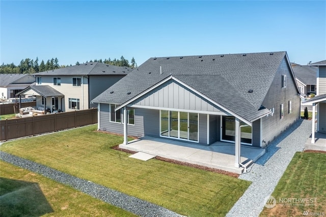 rear view of house featuring a patio area and a lawn