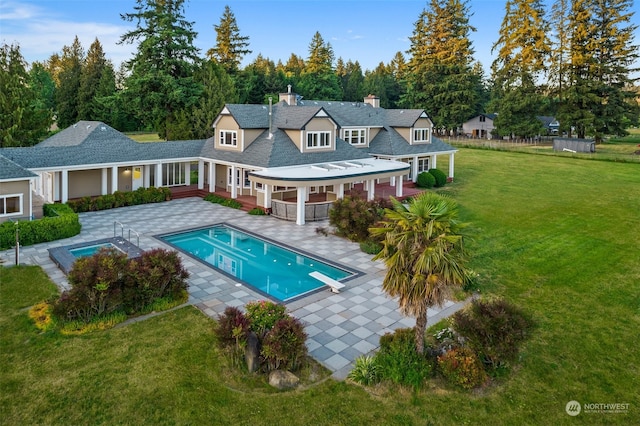 back of house with a yard and a patio area