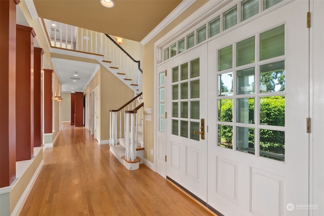 foyer featuring light hardwood / wood-style floors and crown molding