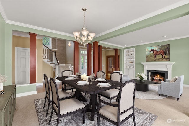 carpeted dining space with an inviting chandelier, ornate columns, and ornamental molding