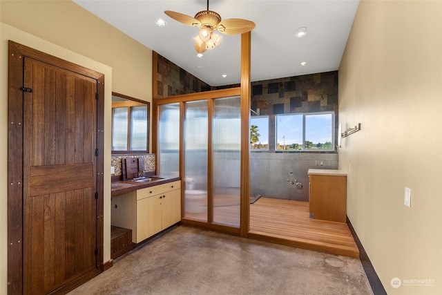 bathroom featuring concrete floors, ceiling fan, and sink