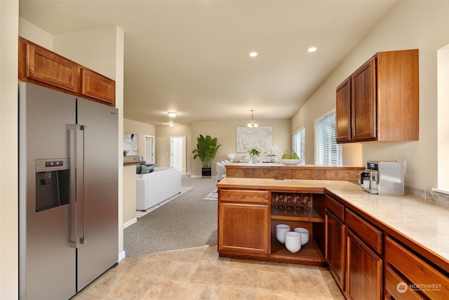 kitchen featuring pendant lighting, light carpet, and high end fridge