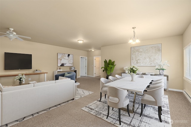 carpeted dining room featuring ceiling fan with notable chandelier