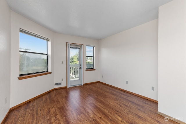 empty room with dark hardwood / wood-style floors