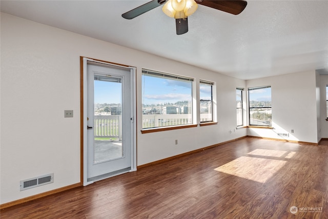 spare room featuring dark hardwood / wood-style floors and ceiling fan