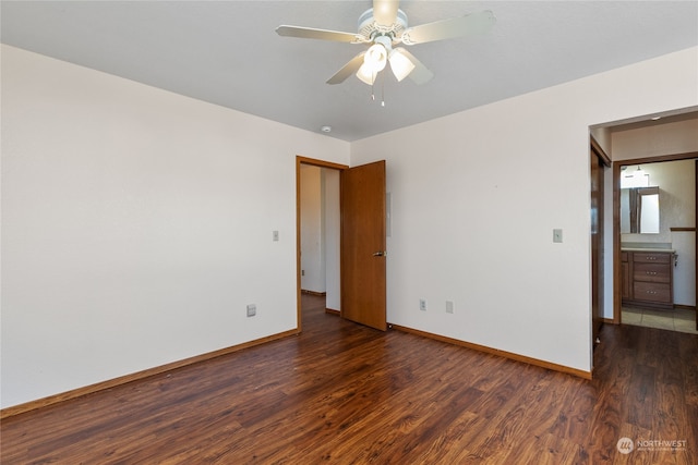 unfurnished room featuring ceiling fan and dark tile flooring