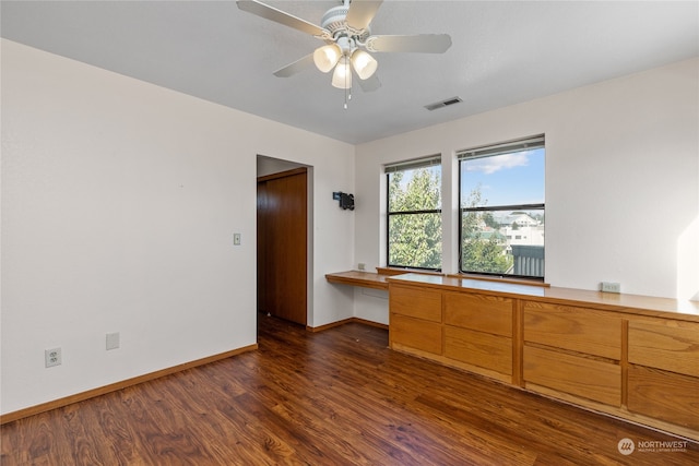 unfurnished room with dark hardwood / wood-style flooring and ceiling fan