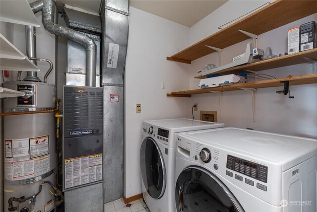 laundry room featuring washer and dryer, washer hookup, water heater, and light tile flooring