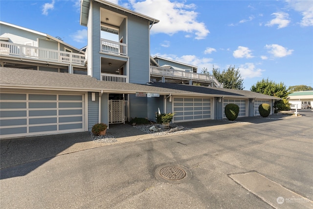 view of front of home featuring a balcony and a garage