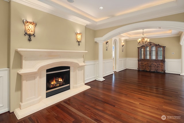 unfurnished living room with dark wood-type flooring, a tray ceiling, a chandelier, and crown molding