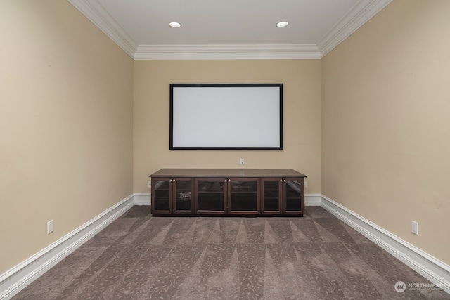 cinema room with crown molding and dark carpet