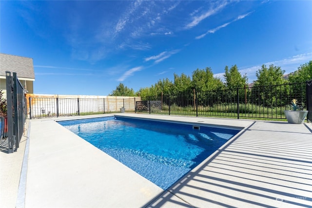 view of swimming pool with fence and a patio