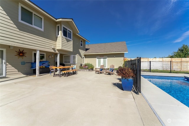 view of pool with a patio area and fence