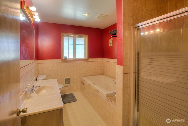 full bathroom featuring tile flooring, toilet, separate shower and tub, vanity, and tile walls