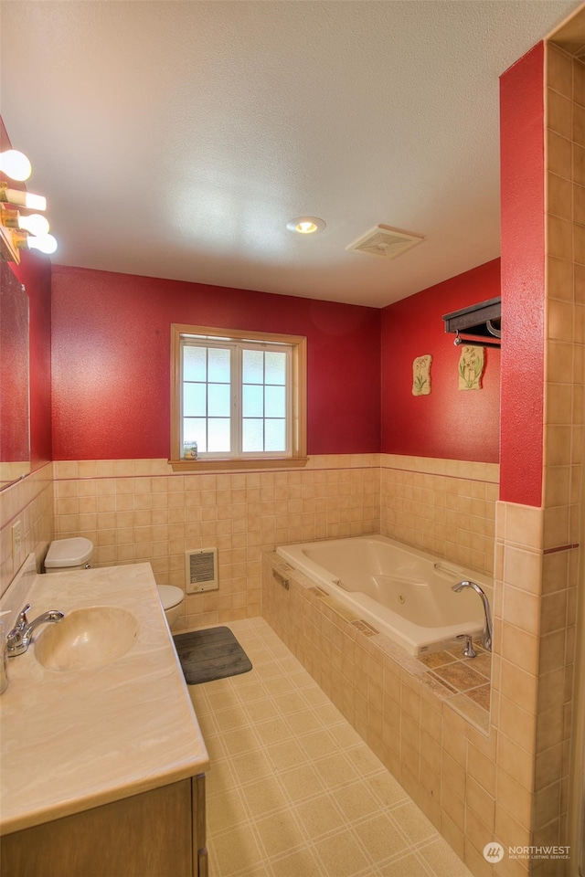 bathroom featuring vanity, tile walls, tile flooring, toilet, and tiled tub