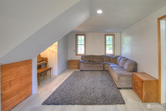 living room with lofted ceiling and light wood-type flooring