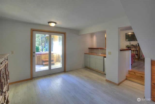 kitchen with light hardwood / wood-style flooring, dishwasher, and sink