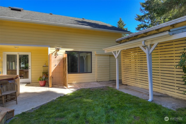 back of property with a yard and a patio area