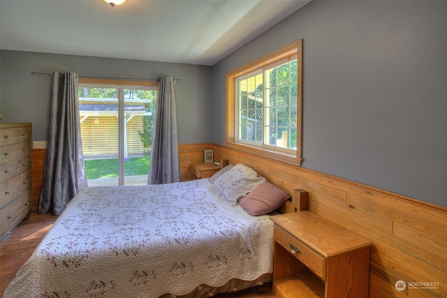 bedroom with dark wood-type flooring and access to outside