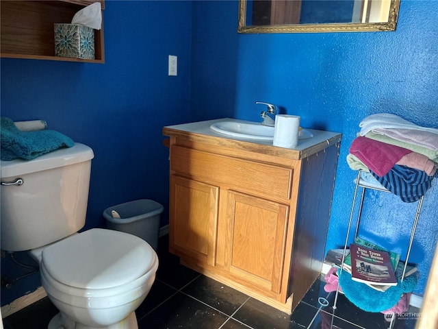 bathroom featuring vanity, tile patterned floors, and toilet