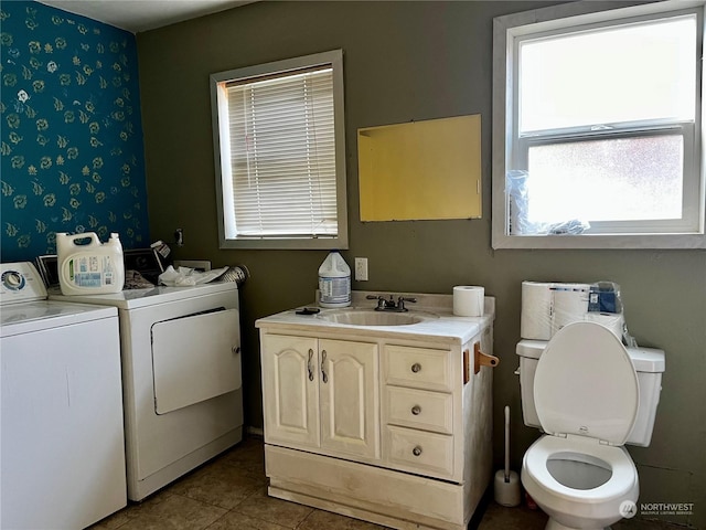 bathroom with vanity, washing machine and clothes dryer, tile patterned floors, and toilet