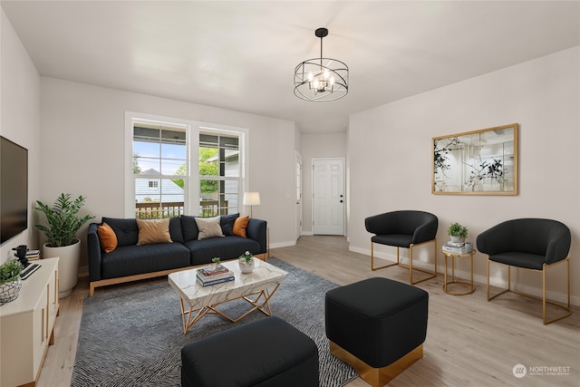 living room featuring light hardwood / wood-style floors and an inviting chandelier