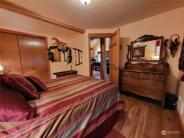 bedroom featuring light wood-type flooring and a closet