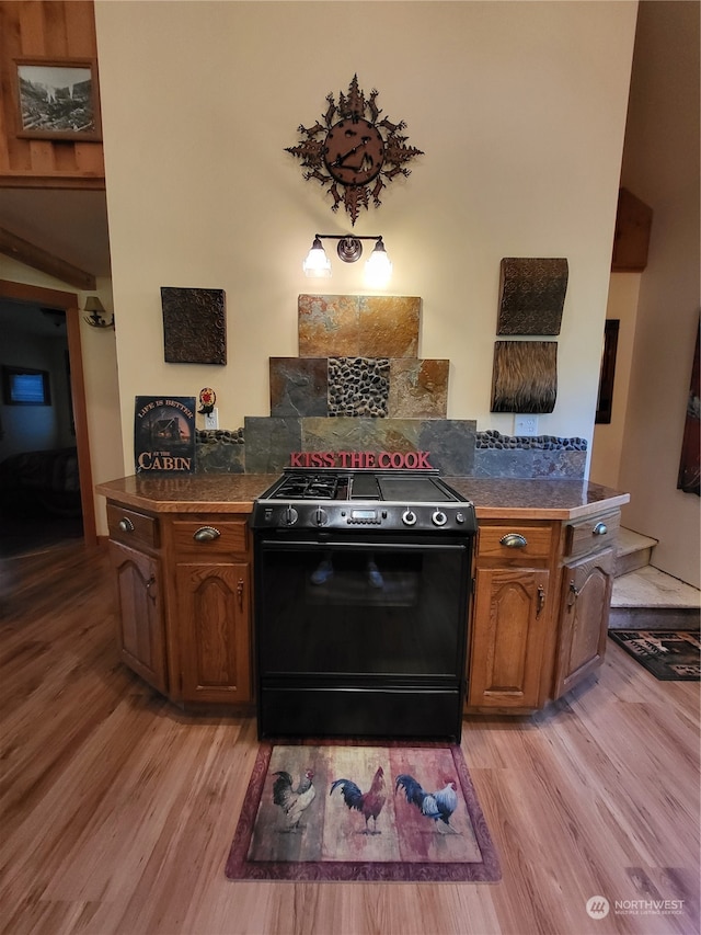 kitchen featuring black stove and light hardwood / wood-style flooring