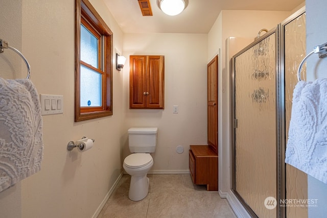 bathroom featuring walk in shower, tile floors, and toilet