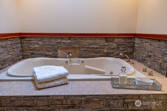 bathroom featuring a relaxing tiled bath