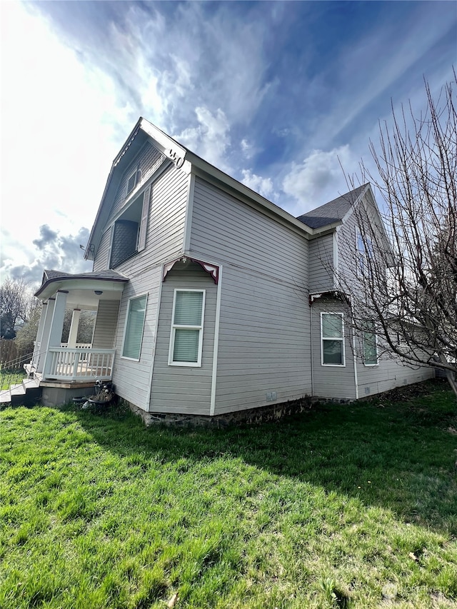 view of side of property with a lawn