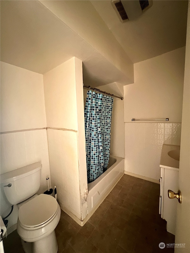 full bathroom featuring tile flooring, toilet, vanity, and shower / bath combo with shower curtain