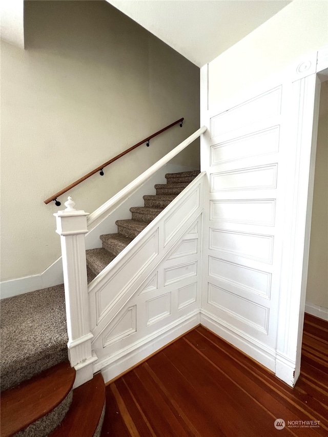 staircase with dark hardwood / wood-style floors